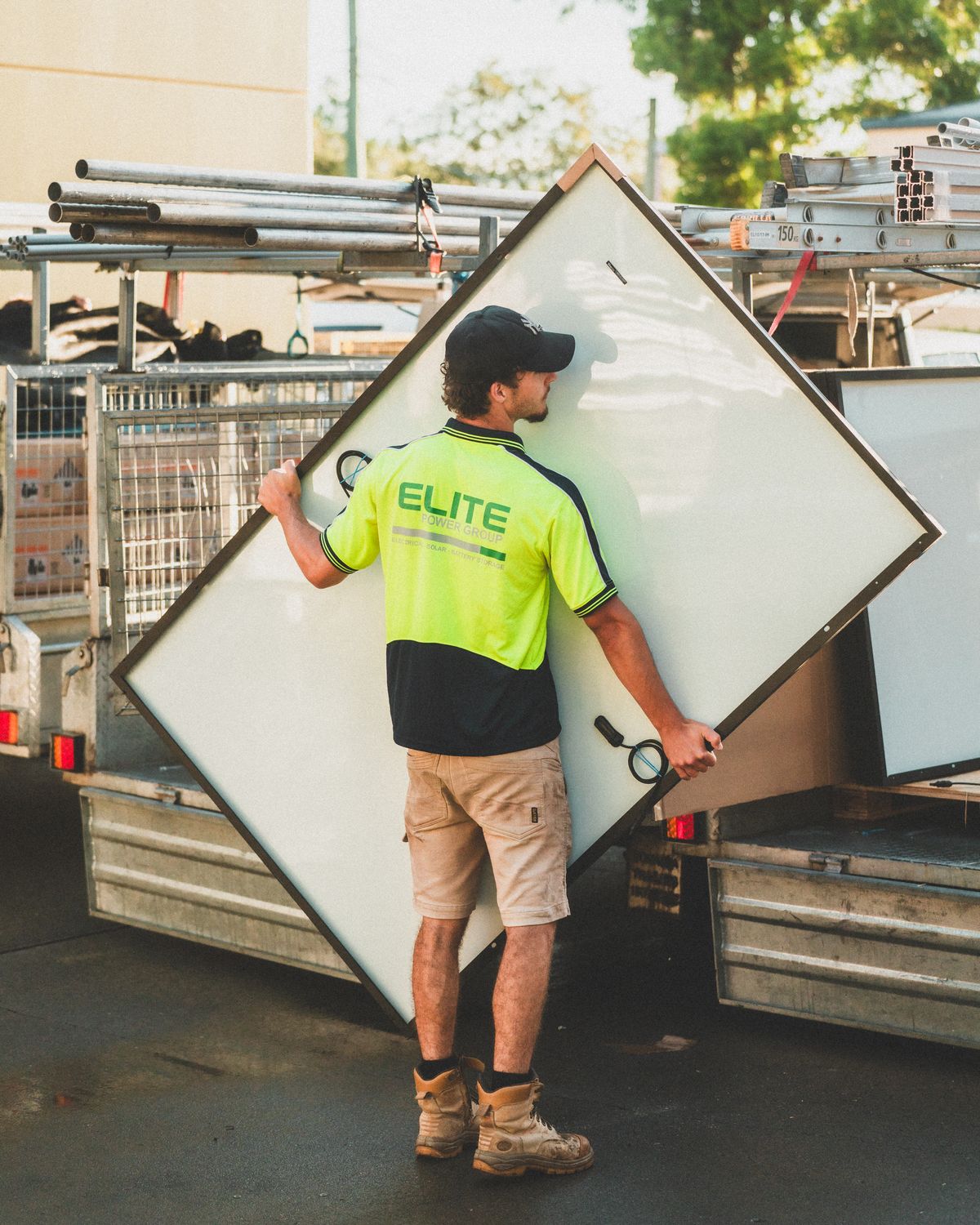 Solar panels being loaded onto a work vehicle