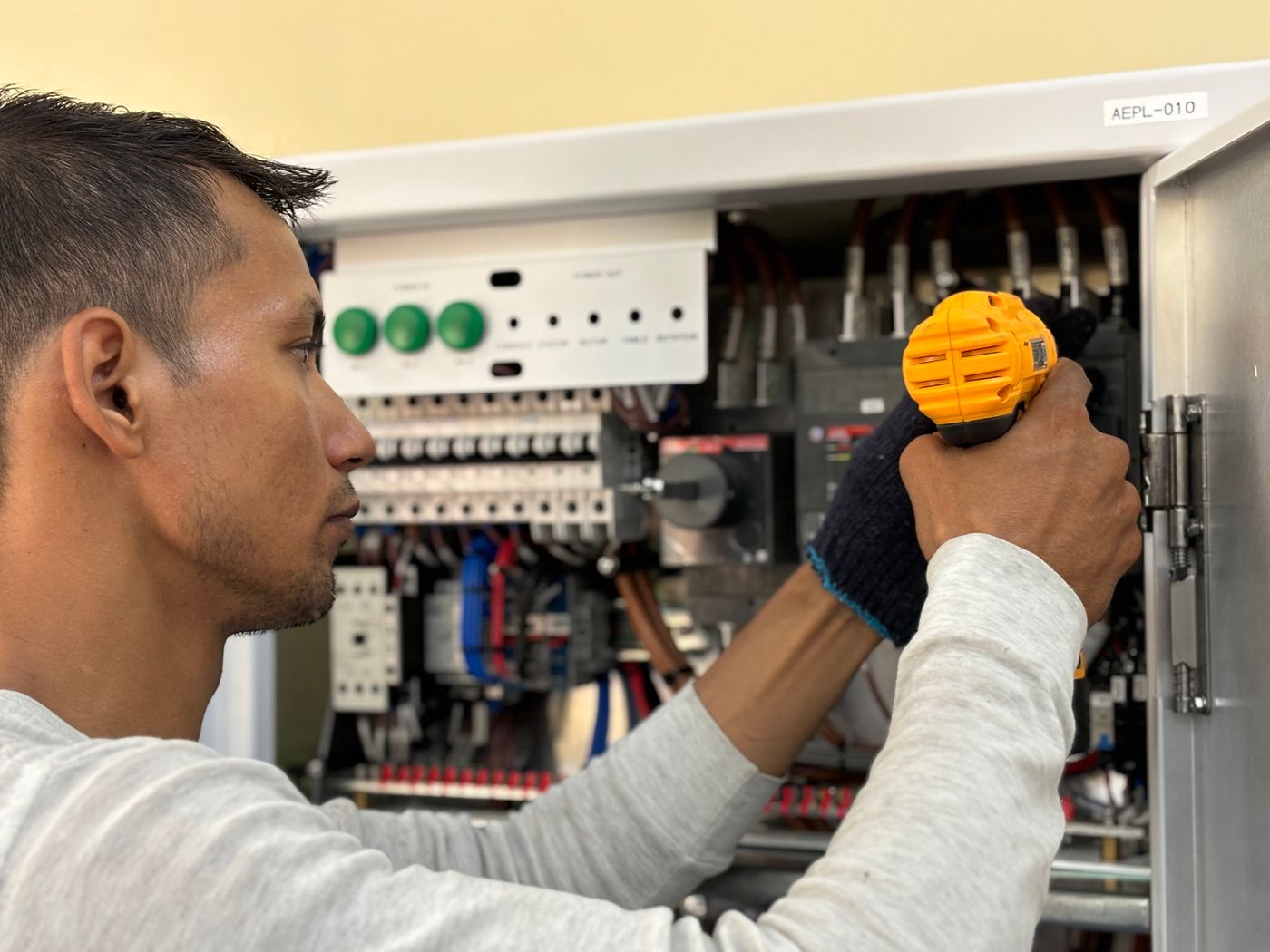 An electrician working on a distribution board