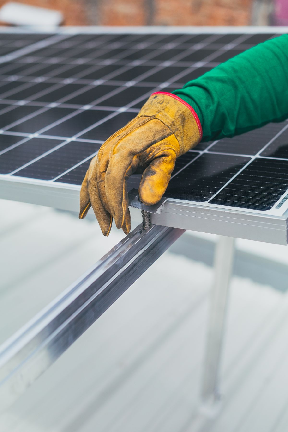 Gloved hands fitting a solar panel