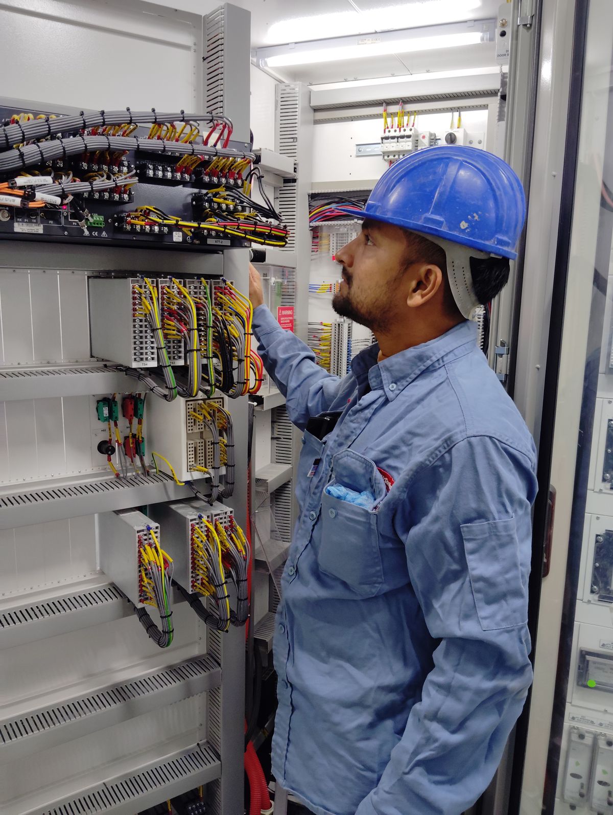 Electrician checking control panel wiring