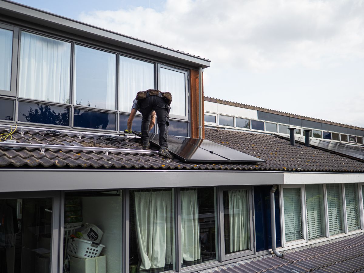 Technician working on a residential roof array