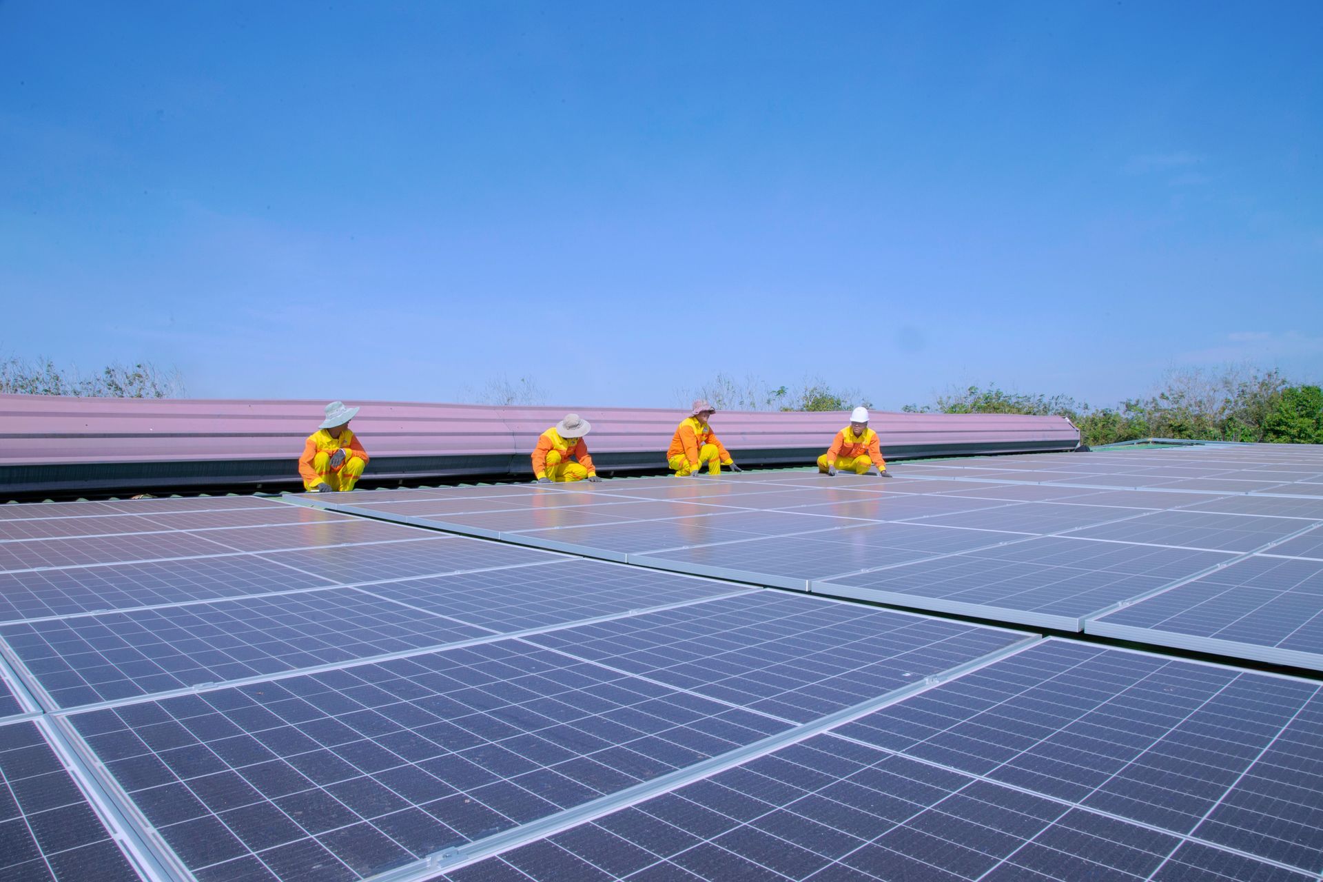 Technicians setting solar panels into their mounting rails
