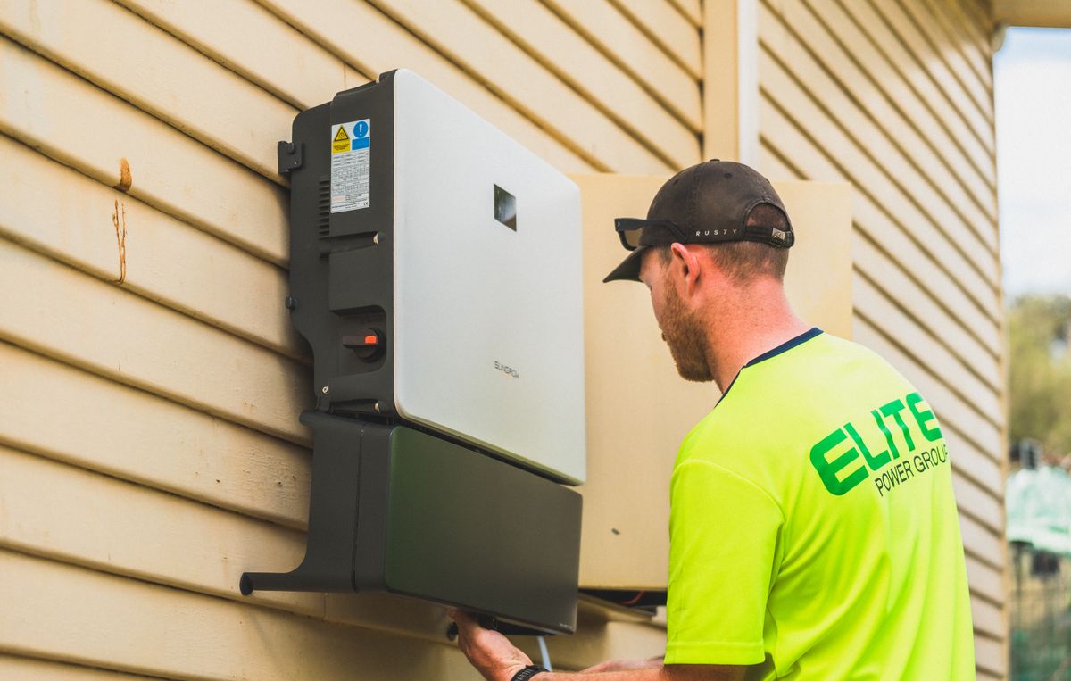 Inverter being wired into a wall-mounted backup system