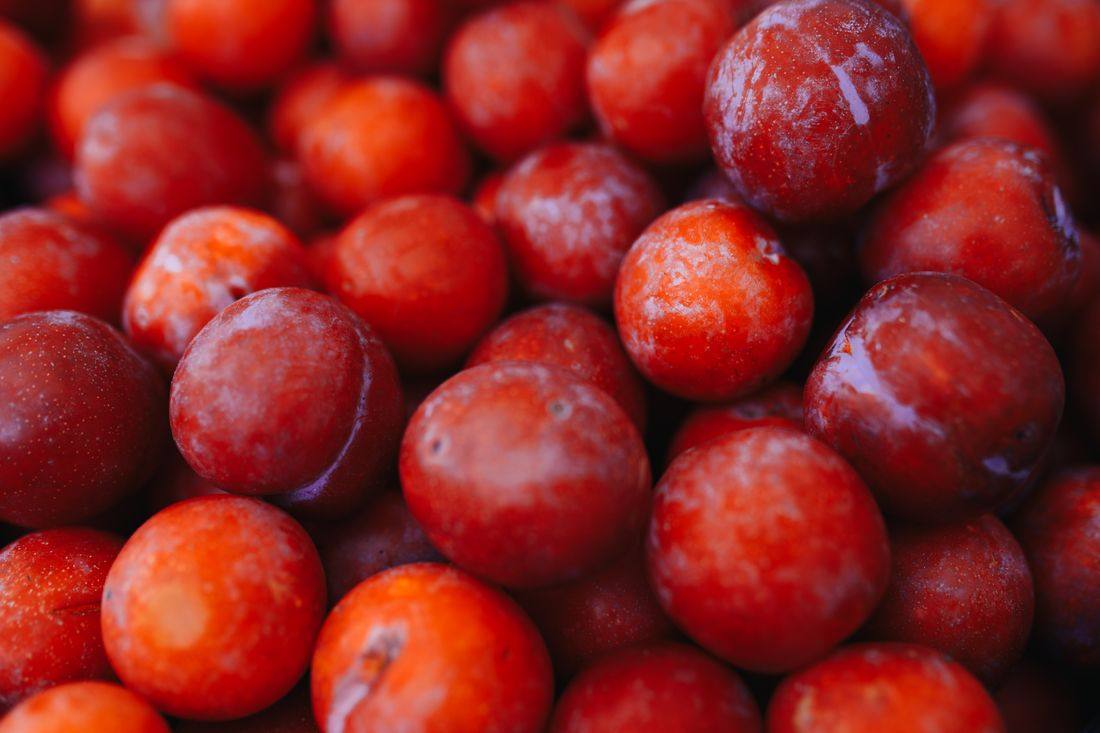 Dark plums in a packing crate