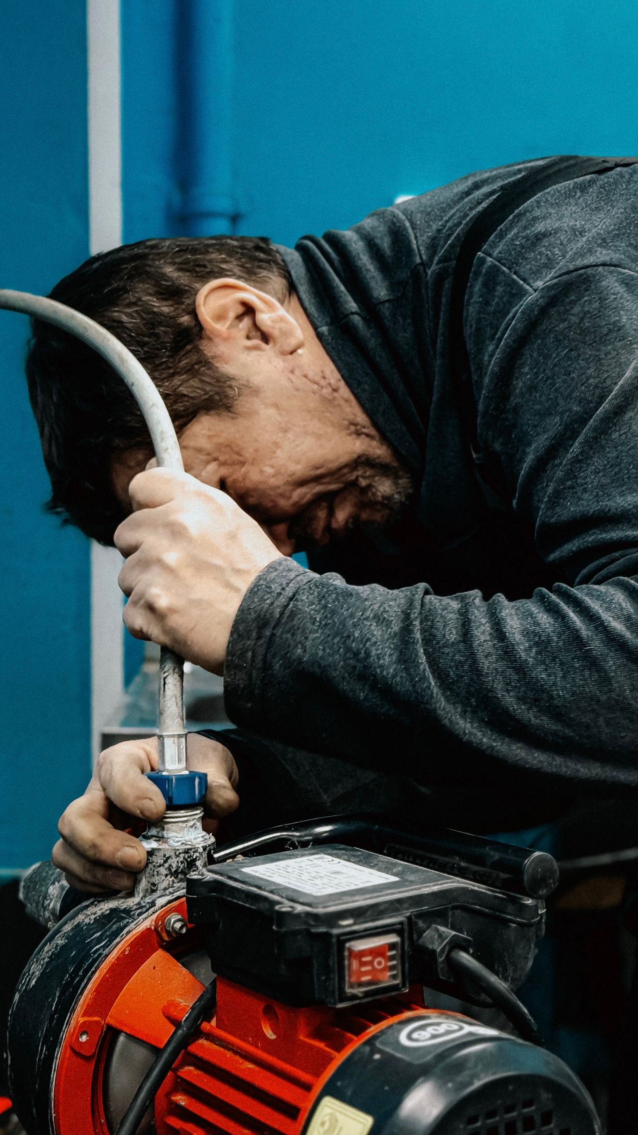 Plumber commissioning a booster pump