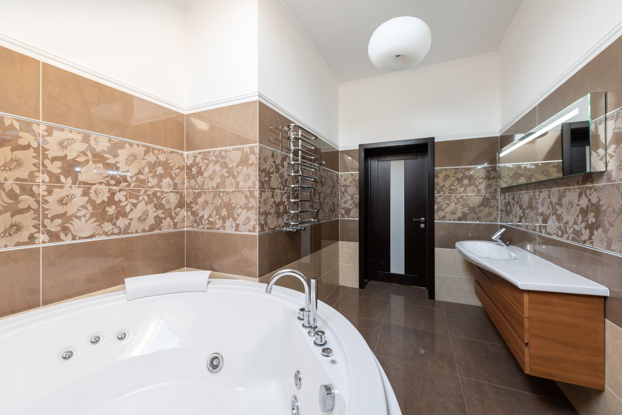 Bathroom with round freestanding tub and timber cabinet