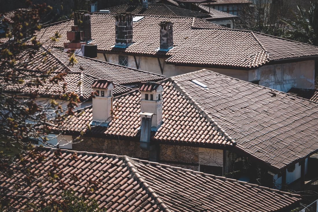 Brown concrete roof tiles on a rendered house